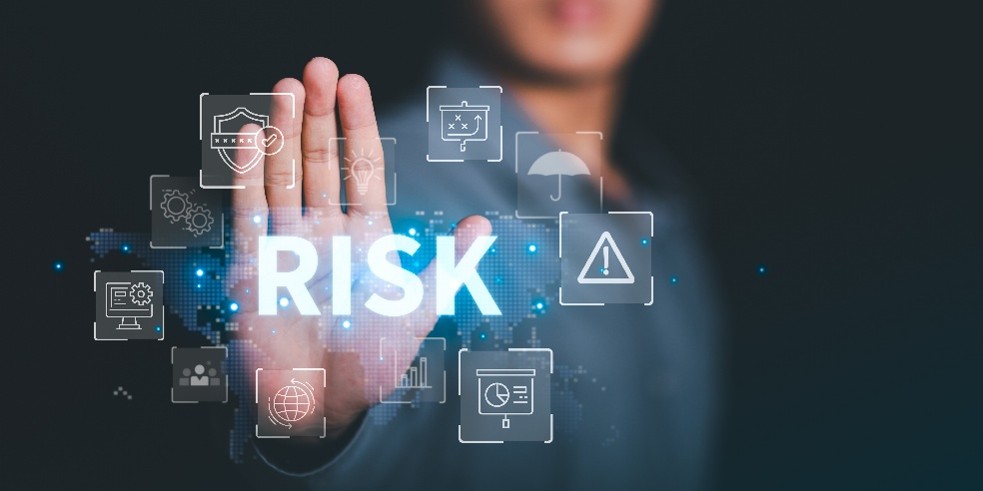 Image of a hand with the word "RISK" overlaid, symbolizing the need for cybersecurity protection and support.