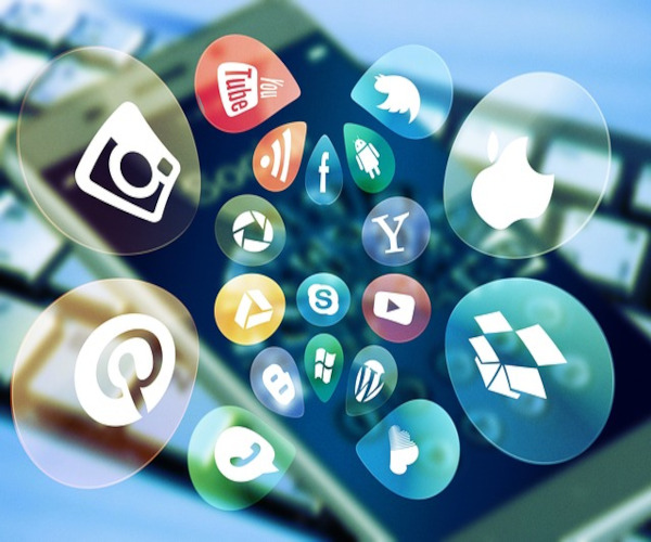 Image of social media icons over a smartphone to represent how Creative Programs and Systems business app development. 