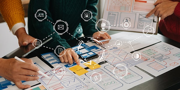 Image of designers working together to create a great digital or online user experience (UX) design for websites and more. 