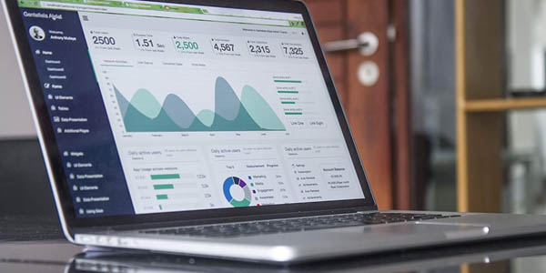 Image of a laptop with analytical data showing on the monitor to indicate that Creative Programs and Systems provides web analytics and reporting.