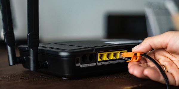 Image of a person plugging in a cable representing that CPS offers network infrastructure builds. 